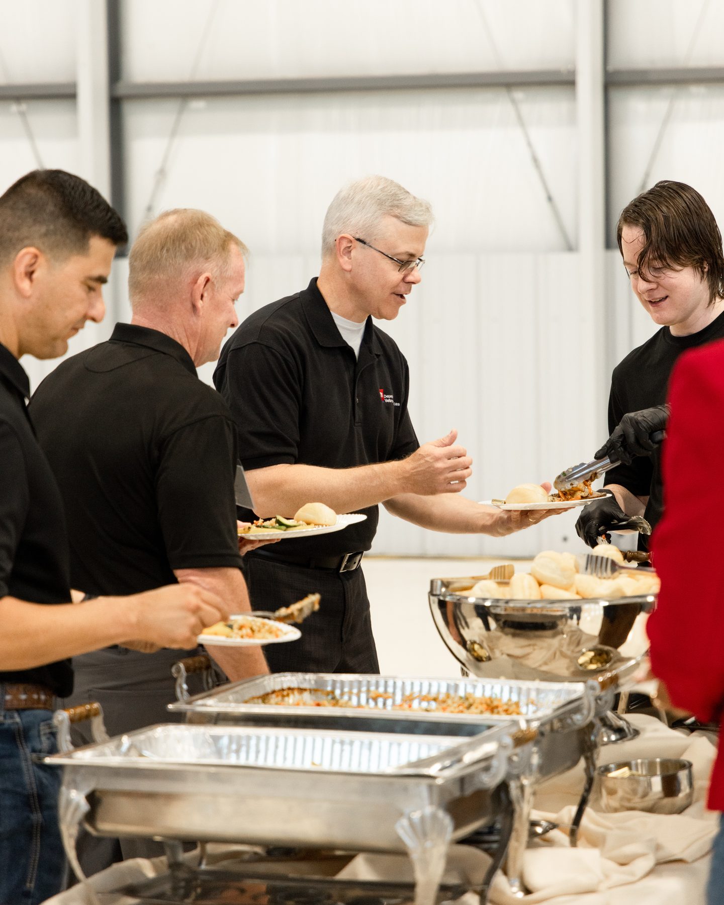 Guests being served at a corporate event buffet