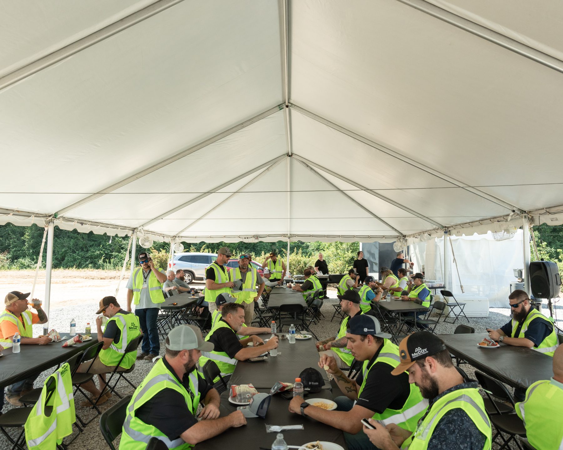 Lunch seating under a tent for a corporate groundbreaking